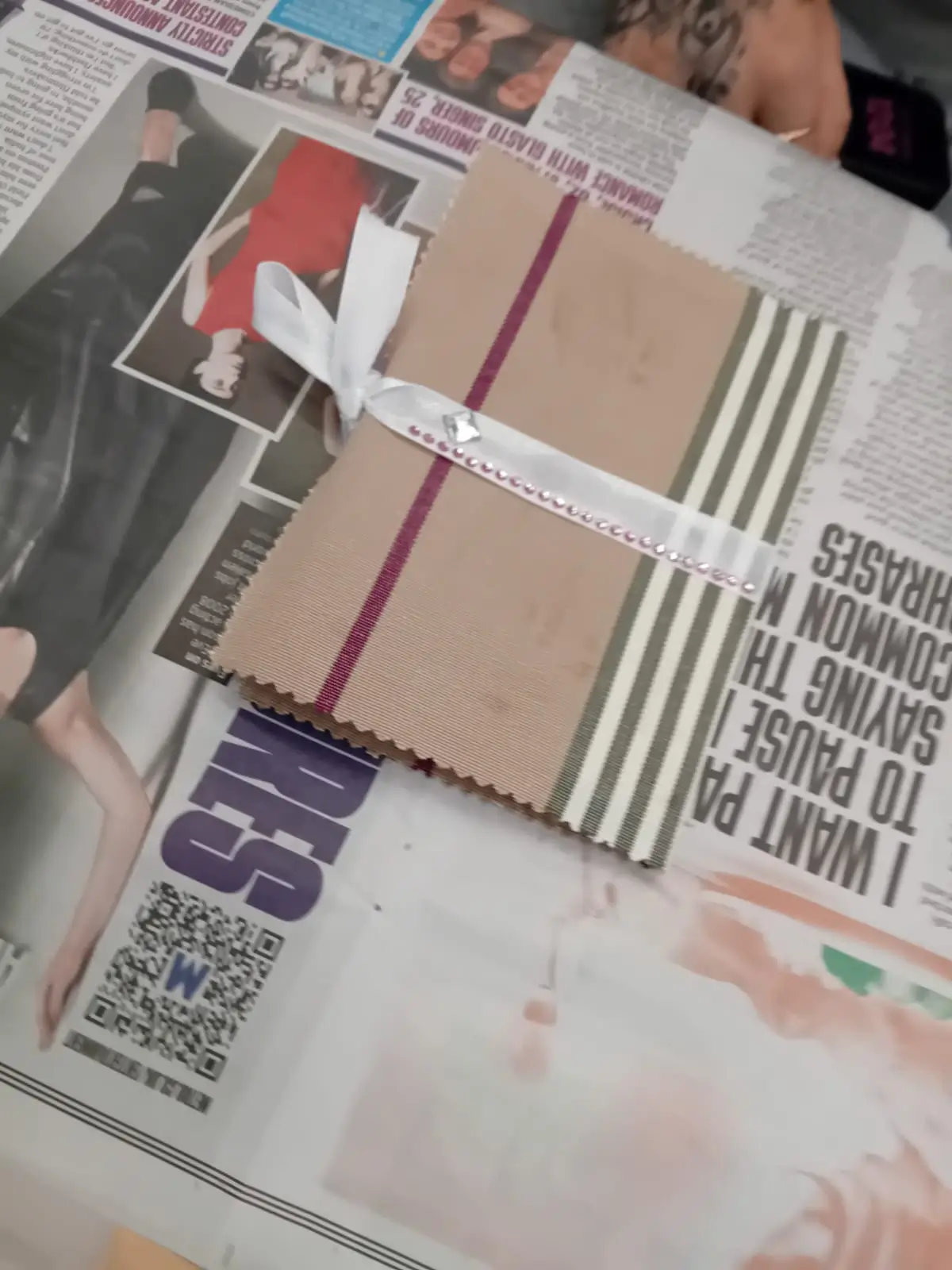 a notebook with a white ribbon tied around it