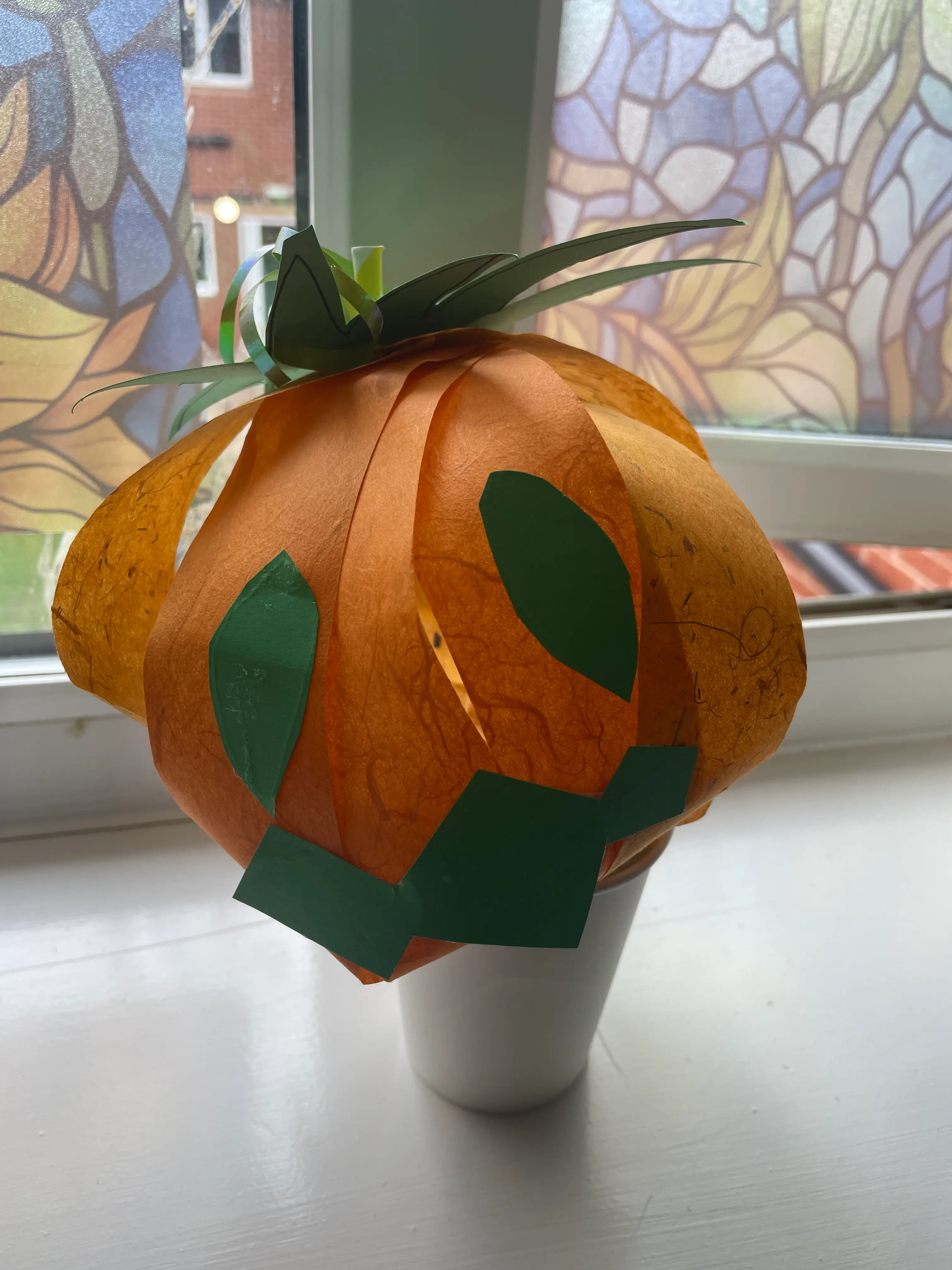 a paper pumpkin with a wicked grin a paper pumpkin with a wicked grin